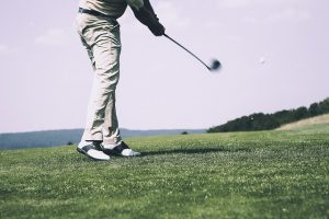 Image is a man playing golf.